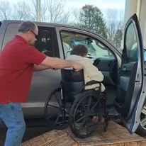 Northridge Gracious Retirement Living Hawthorn Senior Independent Living in Fishers, Indiana resident in a wheelchair being helped into a vehicle