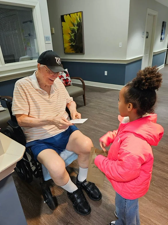 Charter Senior Living of Bowie resident enjoys a visitor and special note