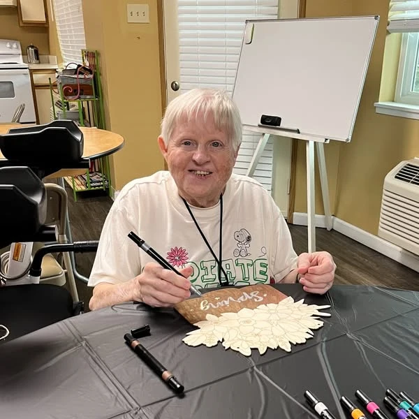 Whealdon Estates by Barclay House senior living community offering independent living in Baton Rouge, LA, resident making spring door crafts to celebrate the start of spring