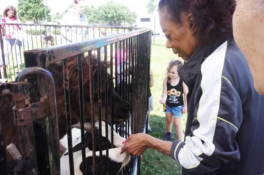 Porter Place Assisted Senior Living Memory Care in Tinley Park, IL resident at a petting zoo