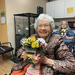 Charter Senior Living of Chattanooga smiling resident with floral creation