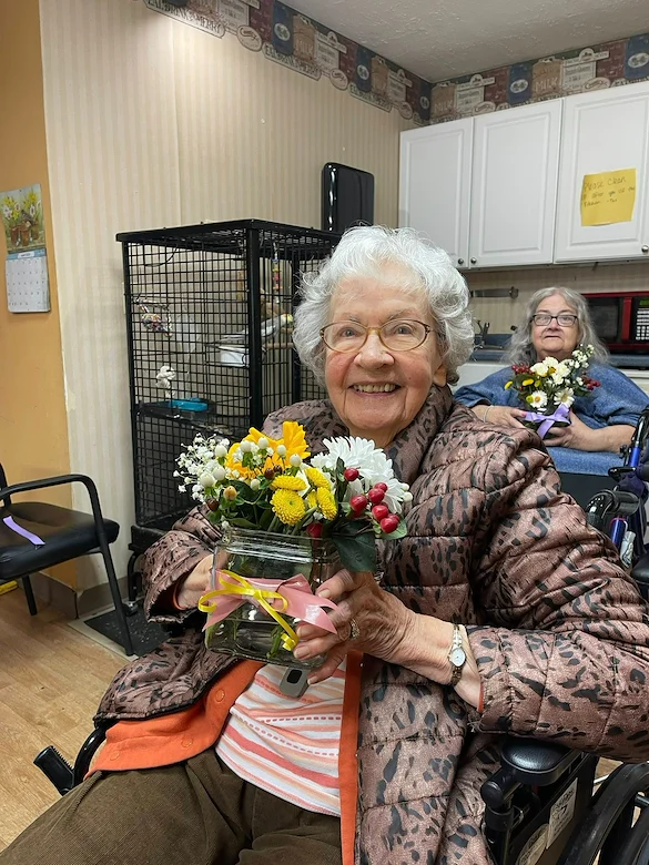 Charter Senior Living of Chattanooga smiling resident with floral creation