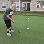 Residents of the Waters of Pewaukee stay active by taking advantage of their new 6-hole putting green