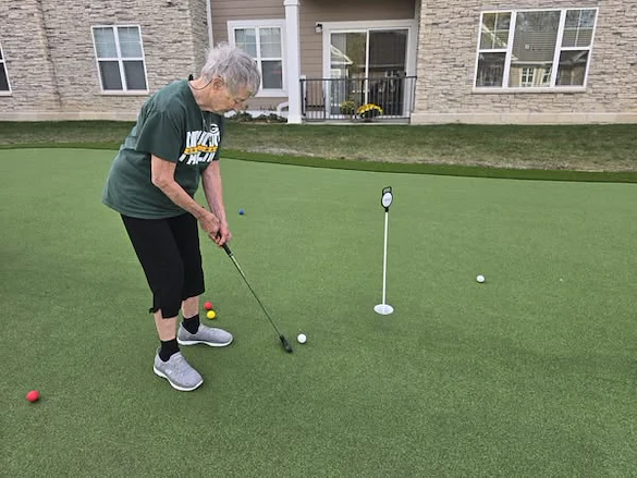 Residents of the Waters of Pewaukee stay active by taking advantage of their new 6-hole putting green
