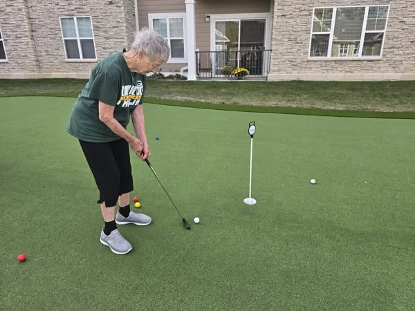 Residents of the Waters of Pewaukee stay active by taking advantage of their new 6-hole putting green