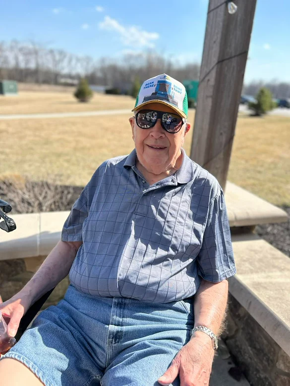 Astral at Auburn, senior living community offering independent living, assisted living, and memory care in Auburn, IN, happy resident outside