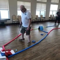 Ivy Creek Gracious Retirement Living Hawthorn Senior independent Living in Glen Mills, Pennsylvania resident playing a mini golf game