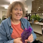 Whispering Pines Gracious Retirement Living Hawthorn Senior Independent Living in Raleigh, North Carolina resident holding a gift bag