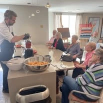 Ovation Heartwood Preserve Senior Living in Omaha, Nebraska residents watching a cook