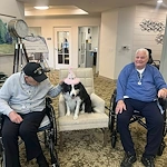 Charter Senior Living of Brookfield residents enjoy a visit from a dog