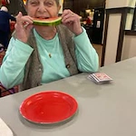 Ashton Gardens Gracious Retirement Living Hawthorn Senior Living Community in Portland, Maine resident eating watermelon