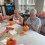 Orchard Heights Gracious Retirement Living Hawthorn Senior Independent Living in Clermont, Florida residents painting pumpkins