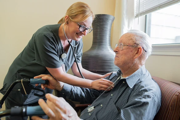 staff using a stethoscope on a resident of Franklin Park Alamo Heights