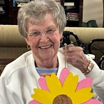 Charter Senior Living of Bowling Green resident smiles with craft