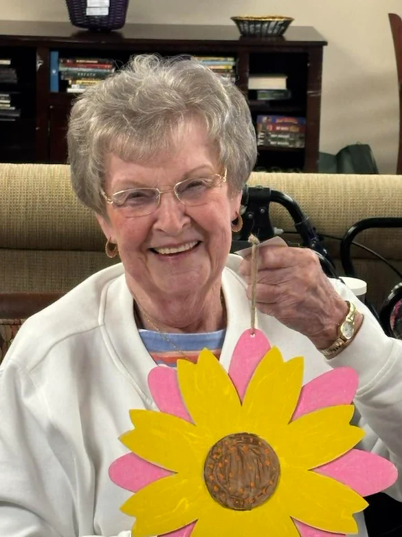 Charter Senior Living of Bowling Green resident smiles with craft