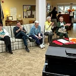 Stoneybrook Lodge Gracious Retirement Living Hawthorn Senior Independent Living in Corvallis, Oregon residents laughing and clapping