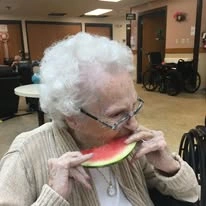 Ascension Living Sacred Heart Village Senior Living in Avilla, Indiana resident eating watermelon