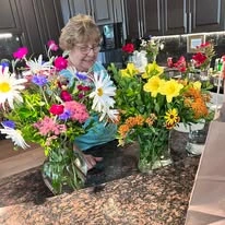 Fairview Estates Gracious Retirement Living Hawthorn Senior Independent Living in Hopkinton, Massachusetts resident with homemade flower bouquets