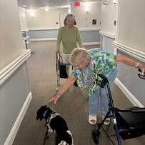 Charter Senior Living of Charlotte resident enjoys the visit from a dog