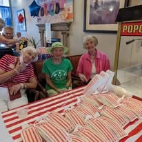 The Peaks At Santa Rita Active Retirement Living Hawthorn Senior Independent Living in Green Valley, Arizona residents in front of a popcorn machine