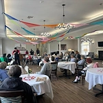 Seniors at Charter Senior Living of Hermitage in Hermitage, TN, gathered together and engaged in a magician’s performance, enjoying interactive entertainment in independent living, assisted living, and memory care.