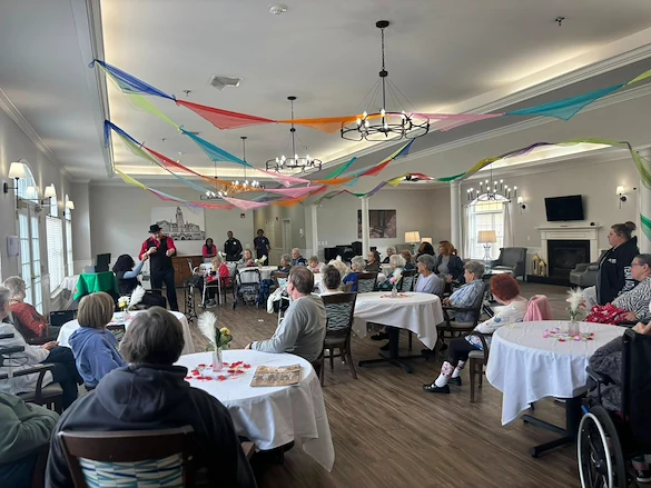 Seniors at Charter Senior Living of Hermitage in Hermitage, TN, gathered together and engaged in a magician’s performance, enjoying interactive entertainment in independent living, assisted living, and memory care.
