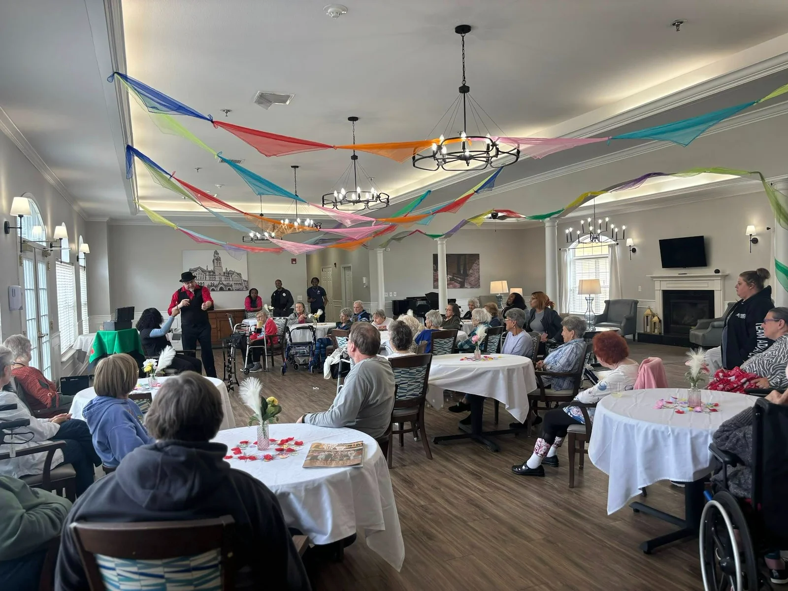 Seniors at Charter Senior Living of Hermitage in Hermitage, TN, gathered together and engaged in a magician’s performance, enjoying interactive entertainment in independent living, assisted living, and memory care.