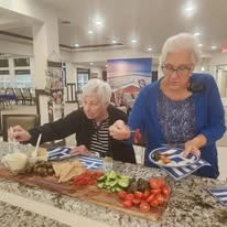 Hudson Estates Gracious Retirement Living Hawthorn Senior Independent Living in Lansdale, Pennsylvania residents grabbing a charcuterie board snack