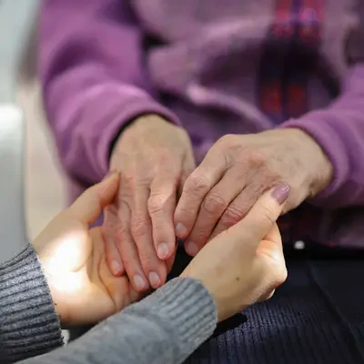 Preparing for the Move | senior and caregiver holding hands