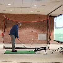 Porter Hills Village resident activity - golfing on a simulator