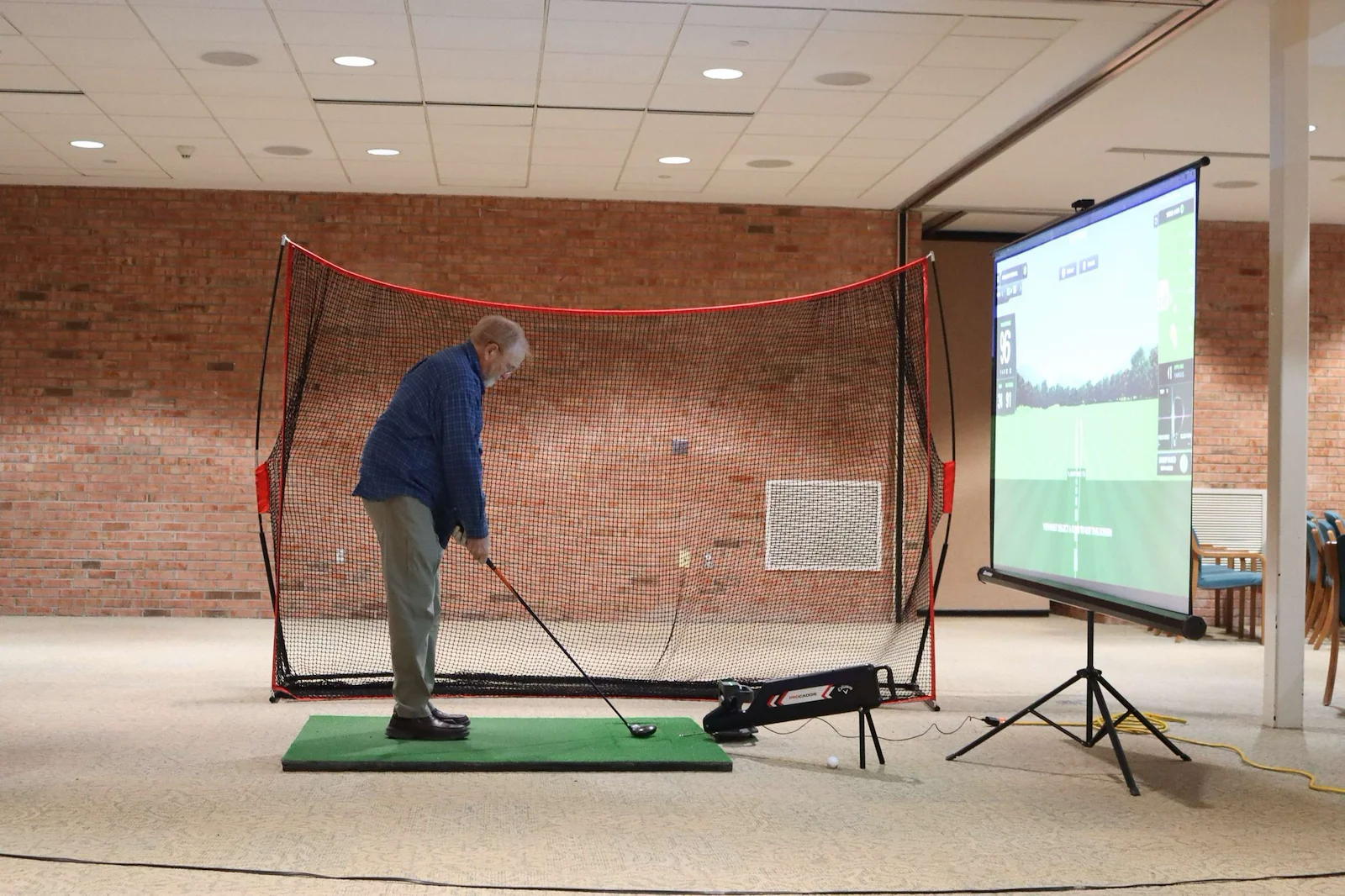 Porter Hills Village resident activity - golfing on a simulator