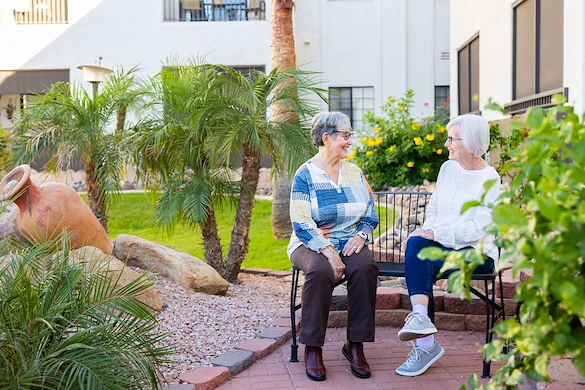 Friends chatting in the garden at Fellowship Square Mesa