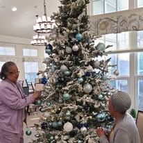 Wilshire Estates Gracious Retirement Living Hawthorn Senior Independent Living in Silver Spring, Maryland residents decorating the Christmas tree