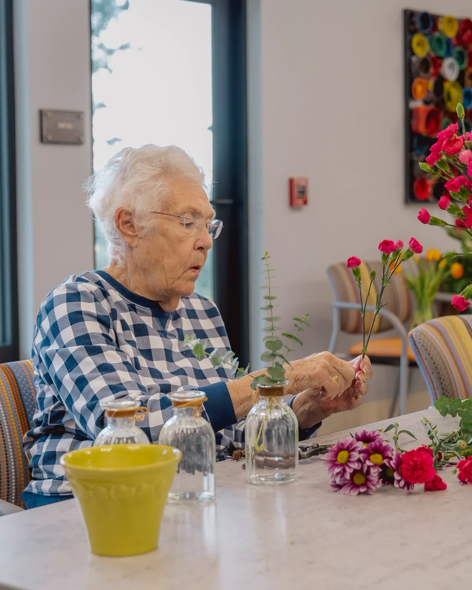 Fieldstone on Clear Creek resident enjoys floral arrangement activity
