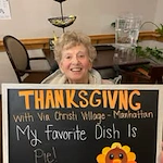 Ascension Living Via Christi Village Manhattan Senior Living in Manhattan, Kansas resident holding a Thanksgiving sign