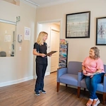 Franklin Park at Sonterra resident being seen by a health staff member