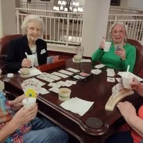 Stoneridge Gracious Retirement Living Hawthorn Senior Independent Living in Cary, North Carolina residents enjoying a treat and playing a card game