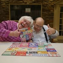 Avina of Milwaukee Senior Living assisted living and independent living in Milwaukee, WI, residents smiling as they finish a puzzle