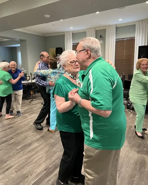 A couple of Verena at Delray residents celebrating St. Patrick's Day by sharing a dance