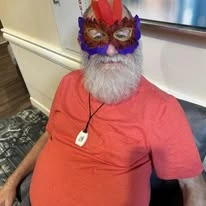Sonata Coconut Creek senior wearing a mardi gras mask and smiling