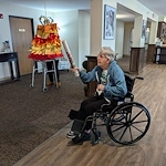 Park Vista Retirement Living North Hill East Moline, IL, resident having fun with a pinata