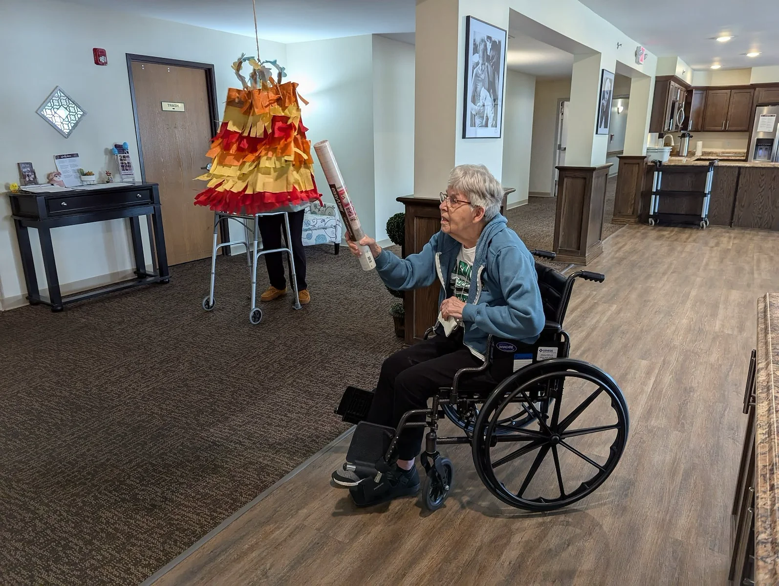 Park Vista Retirement Living North Hill East Moline, IL, resident having fun with a pinata