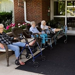 Wesley Manor Assisted Living Community offering assisted living and continuing care retirement community (CCRC) services in Louisville, KY, residents socializing while enjoying time outdoors