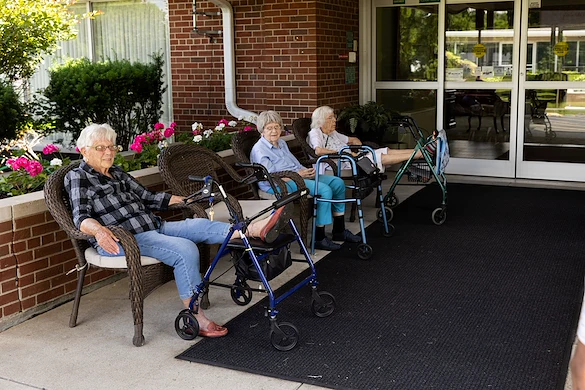 Wesley Manor Assisted Living Community offering assisted living and continuing care retirement community (CCRC) services in Louisville, KY, residents socializing while enjoying time outdoors