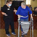 The Oaks Gracious Retirement Living Hawthorn Senior Independent Living in Georgetown, Texas resident being helped by a staff member