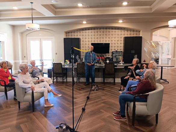 Wilshire Senior Living, independent living, assisted living, and memory care in Burleson, TX, residents playing chair volleyball and enjoying good community