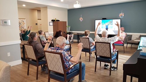 Cascade Creek Memory Care residents performing an activity in the media room.