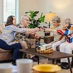 Rosewood Senior Living in Bakersfield, CA, residents visiting and enjoying a glass of wine