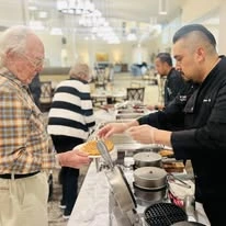 Sequoia Grove Gracious Retirement Living Hawthorn Senior Independent Living in Granite Bay, California resident getting food from chef
