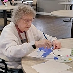American House Westland Venoy senior living community offering independent living, assisted living, and respite care in Westland, MI, resident painting